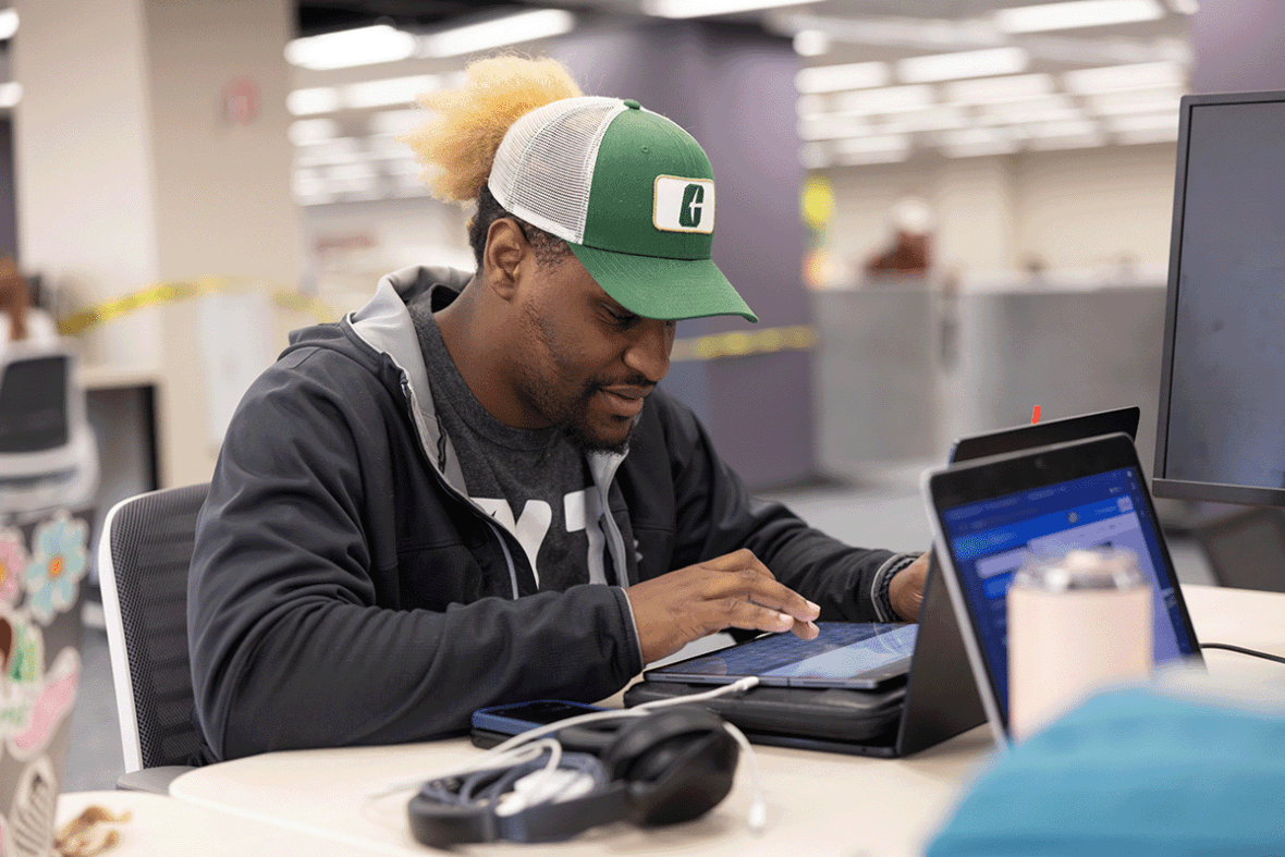 unc charlotte student studying in library